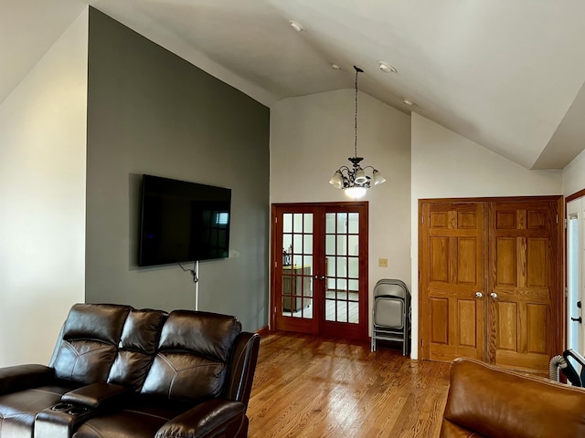 9910 8 Mile Rd, Ceresco, MI 49033 - living area featuring wood finished floors, a chandelier, high vaulted ceiling, and french doors