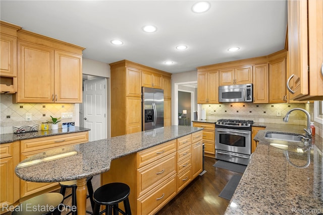 25006 Davenport Ave, Novi, MI 48374 - kitchen featuring appliances with stainless steel finishes, a kitchen island, stone countertops, decorative backsplash, and recessed lighting