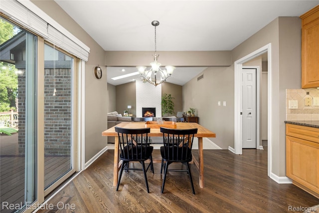 25006 Davenport Ave, Novi, MI 48374 - dining room featuring dark wood-type flooring, a chandelier, and a fireplace