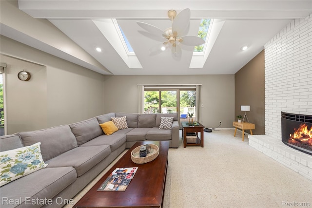 25006 Davenport Ave, Novi, MI 48374 - living room featuring vaulted ceiling, a skylight, a ceiling fan, carpet flooring, and a fireplace
