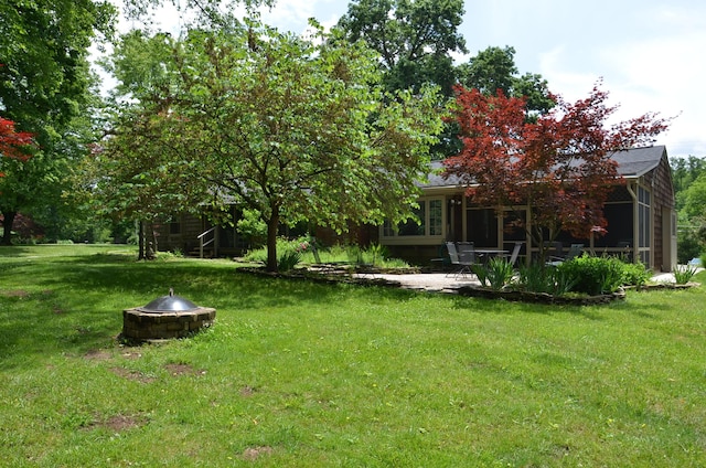 11279 E Cd Ave, Richland, MI 49083 - view of grassy yard featuring a fire pit and a patio area