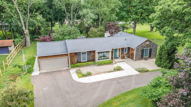 11279 E Cd Ave, Richland, MI 49083 - view of front of home with driveway, a garage, a chimney, roof with shingles, and a front yard