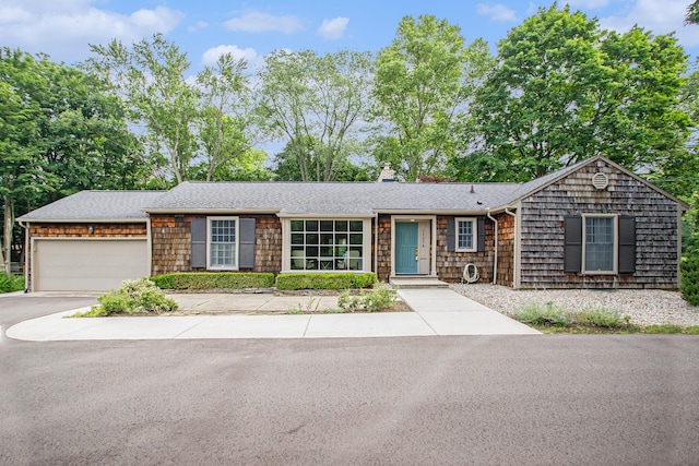 11279 E Cd Ave, Richland, MI 49083 - view of front of property featuring a chimney, a garage, roof with shingles, and driveway