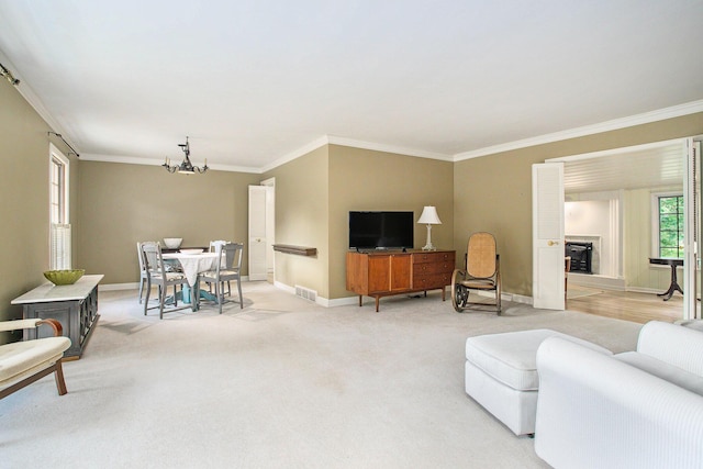 11279 E Cd Ave, Richland, MI 49083 - living room featuring crown molding, a chandelier, a fireplace, and light colored carpet