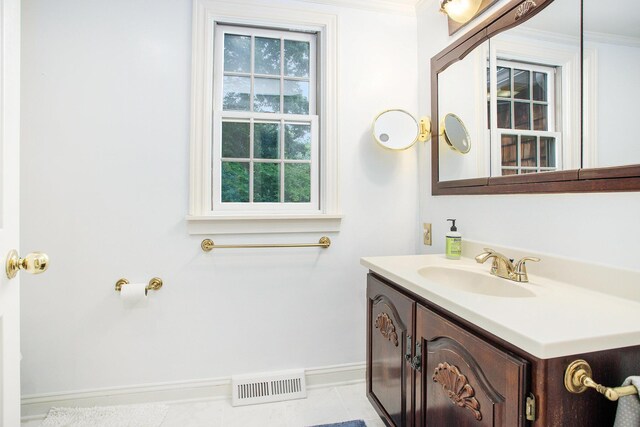 11279 E Cd Ave, Richland, MI 49083 - bathroom with vanity, healthy amount of natural light, ornamental molding, and tile patterned flooring