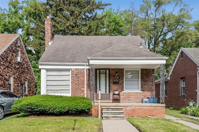 9938 Bramell, Redford, MI 48239 - view of front of house featuring a porch, a chimney, brick siding, a garage, and a shingled roof