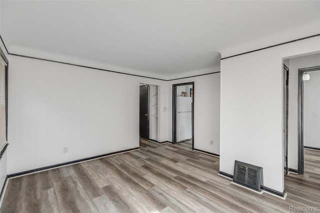 9938 Bramell, Redford, MI 48239 - unfurnished bedroom with wood finished floors and freestanding refrigerator