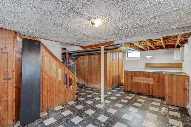 9938 Bramell, Redford, MI 48239 - basement featuring tile patterned floors, stairway, wood walls, and concrete block wall