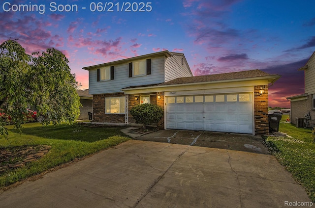 37718 Douglas Ct, Sterling Heights, MI 48310 - traditional-style house with concrete driveway, brick siding, a garage, and a front lawn
