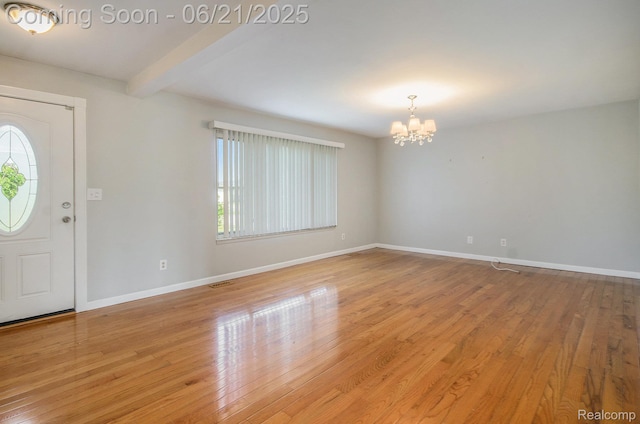 37718 Douglas Ct, Sterling Heights, MI 48310 - entryway with a chandelier, light wood finished floors, and beamed ceiling