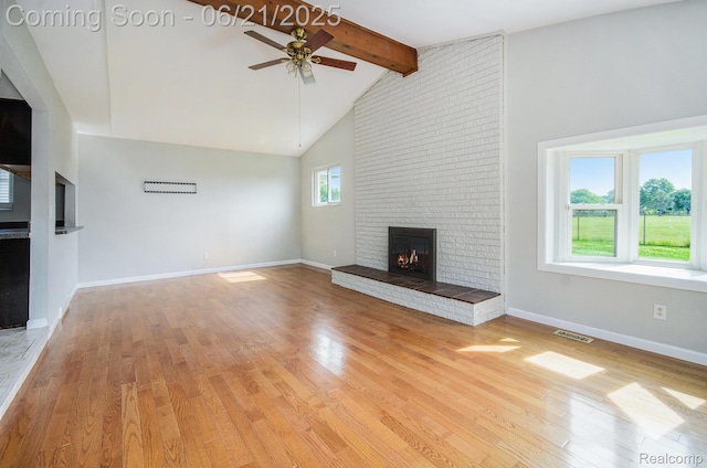 37718 Douglas Ct, Sterling Heights, MI 48310 - unfurnished living room with a brick fireplace, ceiling fan, wood finished floors, beamed ceiling, and high vaulted ceiling