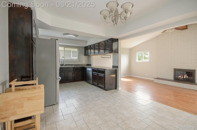 37718 Douglas Ct, Sterling Heights, MI 48310 - kitchen featuring appliances with stainless steel finishes, vaulted ceiling, a chandelier, a fireplace, and dark brown cabinets