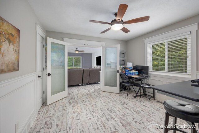 6770 Rivers Edge Ln, Middleville, MI 49333 - office space featuring ceiling fan, healthy amount of natural light, french doors, a decorative wall, and wood finished floors