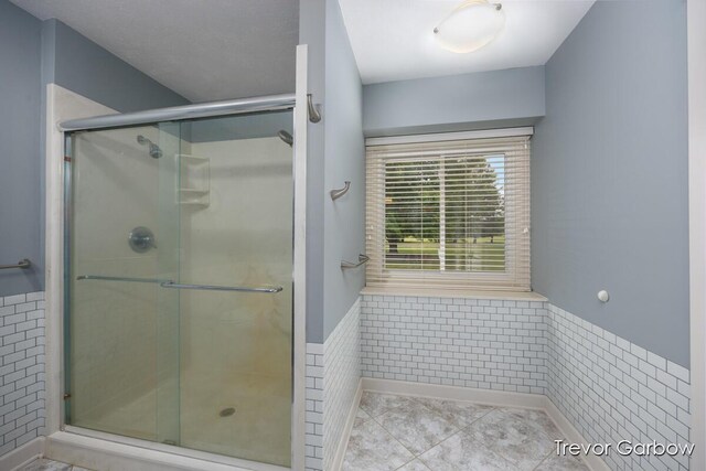 6770 Rivers Edge Ln, Middleville, MI 49333 - full bath with wainscoting, a shower stall, and tile patterned floors
