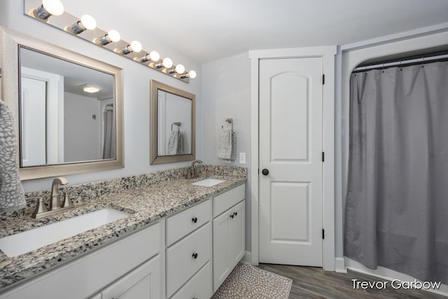 6770 Rivers Edge Ln, Middleville, MI 49333 - bathroom with double vanity, wood finished floors, and shower / bath combo