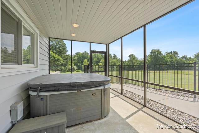 6770 Rivers Edge Ln, Middleville, MI 49333 - sunroom with a jacuzzi and view of scattered trees