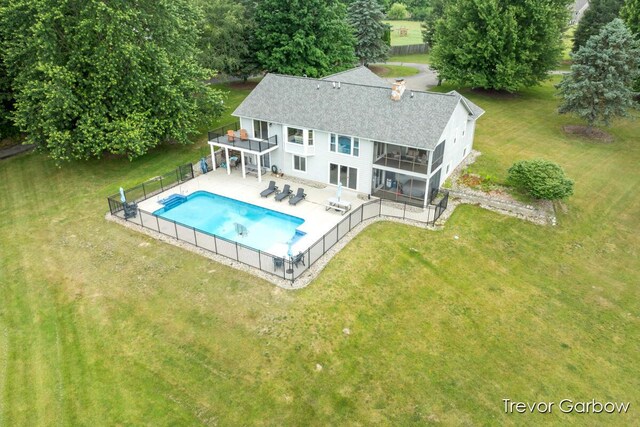 6770 Rivers Edge Ln, Middleville, MI 49333 - rear view of property featuring a shingled roof, a fenced backyard, a patio, and a balcony