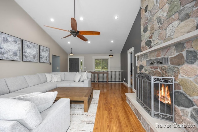 6770 Rivers Edge Ln, Middleville, MI 49333 - living room featuring high vaulted ceiling, a stone fireplace, wood finished floors, a ceiling fan, and recessed lighting