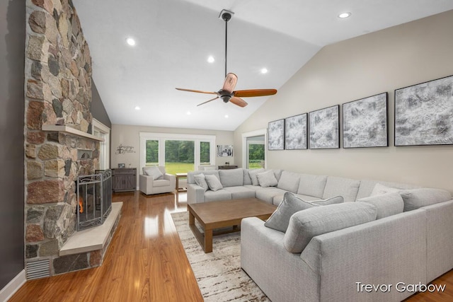 6770 Rivers Edge Ln, Middleville, MI 49333 - living room featuring light wood-style floors, ceiling fan, a fireplace, high vaulted ceiling, and recessed lighting
