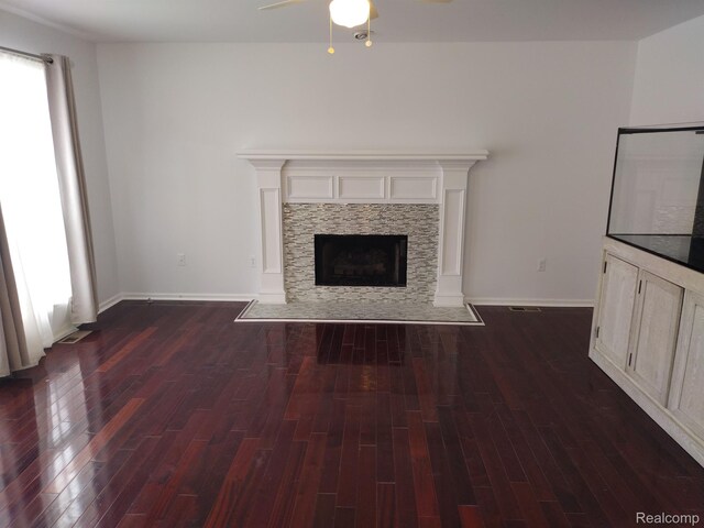 8993 Haymarket St, White Lake, MI 48386 - unfurnished living room featuring a ceiling fan, a fireplace with flush hearth, and dark wood-type flooring