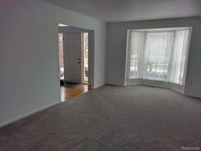 8993 Haymarket St, White Lake, MI 48386 - carpeted entrance foyer featuring baseboards