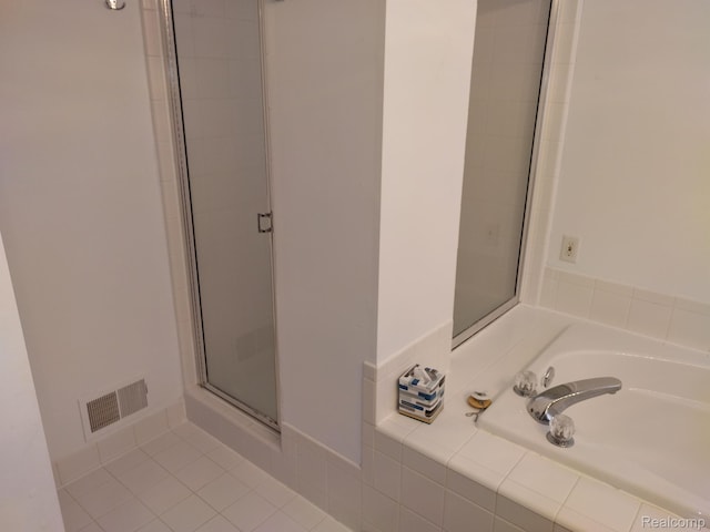 8993 Haymarket St, White Lake, MI 48386 - bathroom with a shower stall, a garden tub, and tile patterned flooring