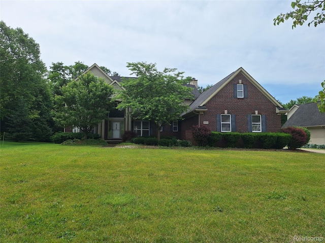 8993 Haymarket St, White Lake, MI 48386 - view of front facade featuring a front lawn, brick siding, and a chimney