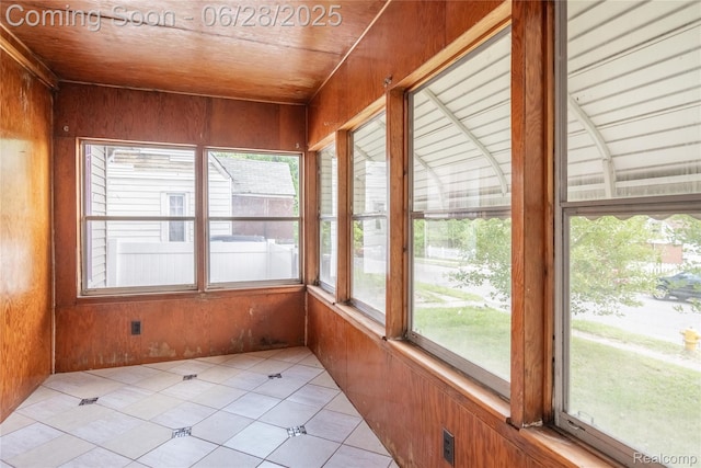 785 Kenilworth Ave, Pontiac, MI 48340 - unfurnished sunroom featuring wooden walls, plenty of natural light, and tile patterned flooring