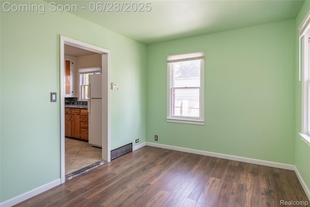 785 Kenilworth Ave, Pontiac, MI 48340 - unfurnished bedroom featuring freestanding refrigerator and wood finished floors