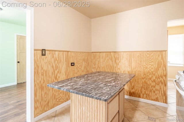 785 Kenilworth Ave, Pontiac, MI 48340 - kitchen with a center island, dark stone countertops, light brown cabinetry, a wainscoted wall, and white range oven