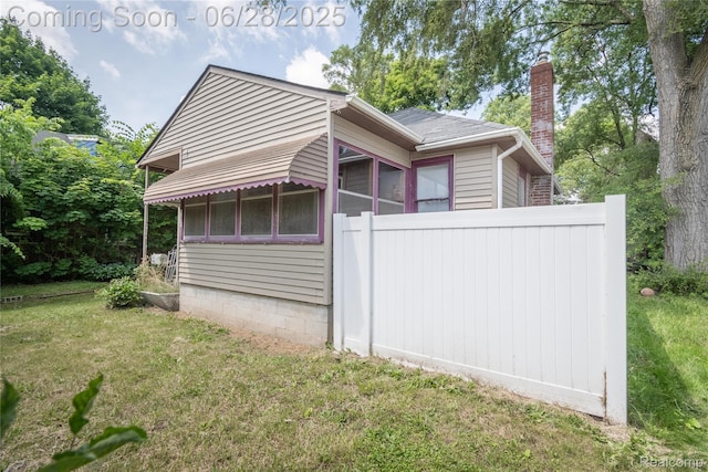 785 Kenilworth Ave, Pontiac, MI 48340 - view of property exterior with a chimney and a lawn
