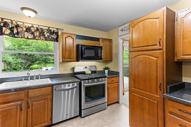 525 Langfield St, Northville, MI 48167 - kitchen with appliances with stainless steel finishes, dark countertops, and brown cabinetry