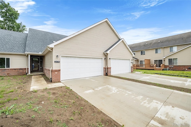 24790 Ashley Ct, Redford, MI 48239 - view of front of house featuring brick siding, a garage, concrete driveway, and roof with shingles