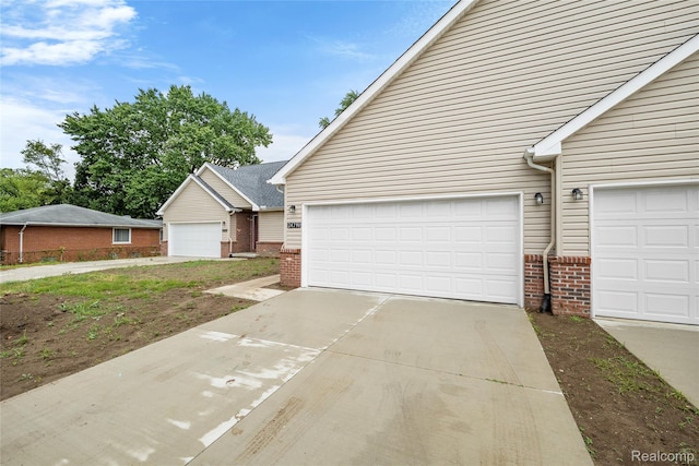 24790 Ashley Ct, Redford, MI 48239 - view of front facade featuring brick siding, driveway, and a garage