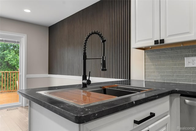24790 Ashley Ct, Redford, MI 48239 - kitchen view of tasteful backsplash, white cabinets, stainless steel dishwasher, and recessed lighting