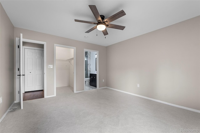 24790 Ashley Ct, Redford, MI 48239 - unfurnished bedroom featuring light carpet, a closet, connected bathroom, a ceiling fan, and a spacious closet