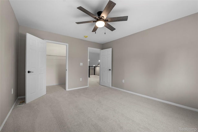 24790 Ashley Ct, Redford, MI 48239 - unfurnished bedroom featuring light carpet, a closet, a spacious closet, and a ceiling fan