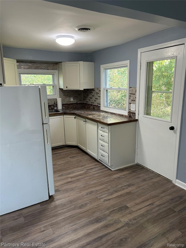 1492 Mason Rd, Howell, MI 48843 - kitchen featuring freestanding refrigerator, dark countertops, decorative backsplash, and plenty of natural light