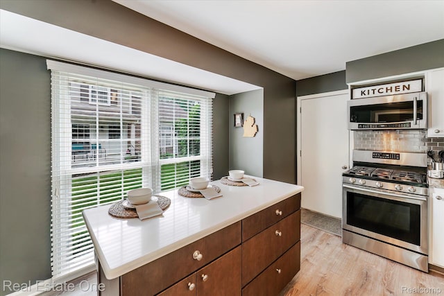 1106 Kings Cove Dr Unit 355, Rochester, MI 48306 - kitchen with appliances with stainless steel finishes, backsplash, light wood-style floors, and light countertops