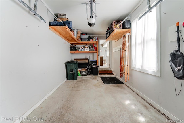 1106 Kings Cove Dr Unit 355, Rochester, MI 48306 - garage featuring a workshop area and a garage door opener