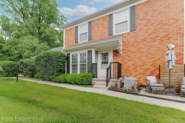 1106 Kings Cove Dr Unit 355, Rochester, MI 48306 - view of front facade featuring a front lawn and brick siding