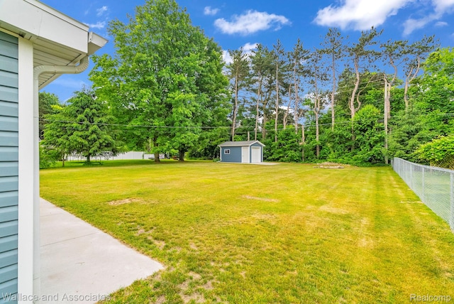 6761 Mels Dr, Ruby, MI 48049 - view of yard with a detached garage and a storage shed