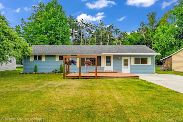 6761 Mels Dr, Ruby, MI 48049 - view of front of home featuring a front lawn, a deck, driveway, and roof with shingles