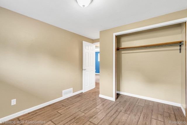 6761 Mels Dr, Ruby, MI 48049 - unfurnished bedroom with wood finished floors and a closet