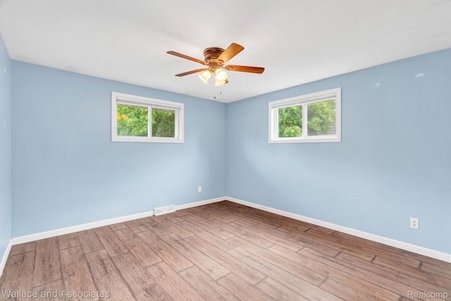 6761 Mels Dr, Ruby, MI 48049 - unfurnished room with healthy amount of natural light, wood finished floors, and ceiling fan