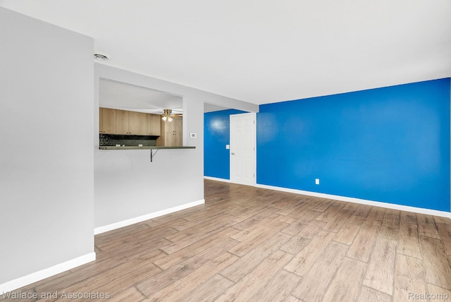 6761 Mels Dr, Ruby, MI 48049 - unfurnished living room featuring wood finished floors and a ceiling fan
