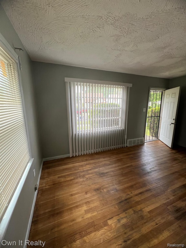 8620 Fielding St, Detroit, MI 48228 - empty room featuring hardwood / wood-style flooring and a textured ceiling