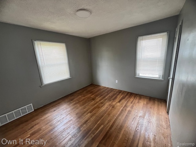 8620 Fielding St, Detroit, MI 48228 - empty room featuring dark wood finished floors and a textured ceiling