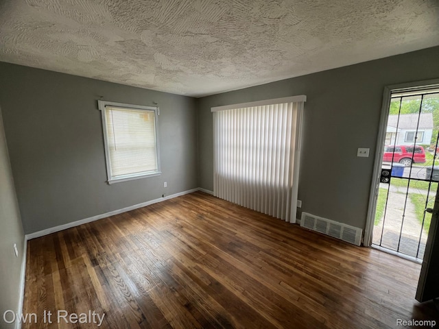 8620 Fielding St, Detroit, MI 48228 - empty room with wood-type flooring and a textured ceiling