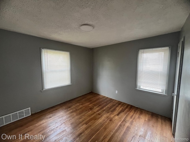 8620 Fielding St, Detroit, MI 48228 - unfurnished room with wood finished floors and a textured ceiling